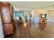 Open dining area featuring hardwood floors, chandelier, and well-preserved furniture at 136 Dogwood Trl, Leesburg, FL 34748