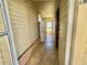 A light colored hallway with cream colored walls, brick details, and access to the yard at 136 Dogwood Trl, Leesburg, FL 34748