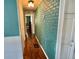 Hallway with unique brick accent wall design, leading to other rooms at 136 Dogwood Trl, Leesburg, FL 34748