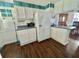 Compact kitchen with functional layout, refrigerator, and microwave oven at 136 Dogwood Trl, Leesburg, FL 34748