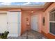 Inviting front entryway with terracotta tile flooring and sun-shaped wall art at 1504 Aalto Pl, The Villages, FL 32159