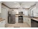 Modern kitchen with white cabinets, stainless steel appliances, and tile flooring at 1504 Aalto Pl, The Villages, FL 32159