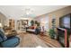 Open living room showcasing hardwood floors and a view into the dining and kitchen areas at 1504 Aalto Pl, The Villages, FL 32159