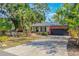 House exterior with palm trees and a spacious driveway at 1625 Virginia Dr, Clermont, FL 34711