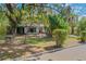 Landscaped front yard with lush greenery and oak trees at 1625 Virginia Dr, Clermont, FL 34711