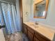 Bathroom with a shower, vanity, and neutral finishes; plus a linen cabinet for extra storage at 169 Bougainvillea Dr, Leesburg, FL 34748