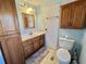 Well-lit bathroom featuring a vanity, toilet, and plenty of storage space at 169 Bougainvillea Dr, Leesburg, FL 34748