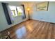 Bedroom featuring wood-look floors, a lamp, and a sunlit window with view at 169 Bougainvillea Dr, Leesburg, FL 34748