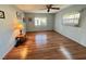 Bedroom with wood-look floors, a ceiling fan, and natural light from the windows at 169 Bougainvillea Dr, Leesburg, FL 34748