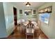 Dining room with wood floors, and an accent light fixture above the table at 169 Bougainvillea Dr, Leesburg, FL 34748