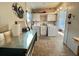 Bright laundry room featuring a washer, dryer, sink, cabinets, and metallic utility table at 169 Bougainvillea Dr, Leesburg, FL 34748