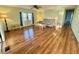 Inviting living room with wood floors, a ceiling fan, and natural light from a window at 169 Bougainvillea Dr, Leesburg, FL 34748