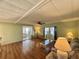 Living room with wood floors, sliding glass doors and lots of natural light at 169 Bougainvillea Dr, Leesburg, FL 34748