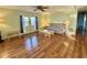 Cozy living room featuring hardwood floors, a ceiling fan, and a comfortable sofa with side tables at 169 Bougainvillea Dr, Leesburg, FL 34748