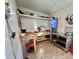 Utility room with shelving, wood-topped work tables and stainless steel shelving at 169 Bougainvillea Dr, Leesburg, FL 34748