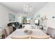 Bright dining room with white table, gray chairs, and view of living room and lake at 17442 Blazing Star Cir, Clermont, FL 34714