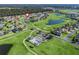 Community aerial view of a pool, golf course, and single-Gathering homes at 17525 Se 121St Cir, Summerfield, FL 34491