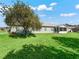 A spacious backyard features a screened in lanai and beautiful tree at 17525 Se 121St Cir, Summerfield, FL 34491