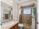 Well-lit bathroom with decorative shower and neutral countertops at 17525 Se 121St Cir, Summerfield, FL 34491