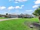 Single-story home with attached garage and spacious lawn at 17525 Se 121St Cir, Summerfield, FL 34491