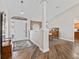 Inviting foyer featuring wood floors, a decorative pillar, and natural light at 17525 Se 121St Cir, Summerfield, FL 34491