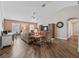 Cozy living room with high ceilings, neutral tones, ceiling fan, and wood-look flooring at 17525 Se 121St Cir, Summerfield, FL 34491