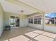 Sunroom with ceiling fan and tile floor looking into kitchen area at 17525 Se 121St Cir, Summerfield, FL 34491