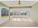 Bright sunroom with tile flooring, many windows, and a ceiling fan at 17525 Se 121St Cir, Summerfield, FL 34491