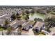 A sunny aerial view of homes surrounding a lake in a residential neighborhood at 17760 Se 91St Gaylark Ave, The Villages, FL 32162