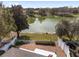 Aerial backyard view showcases a beautiful lake, fence, and manicured lawn at 17760 Se 91St Gaylark Ave, The Villages, FL 32162