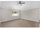 A bright, minimalist bedroom with wood flooring and a modern ceiling fan at 17760 Se 91St Gaylark Ave, The Villages, FL 32162