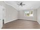 Well-lit bedroom with wood flooring and a large window view at 17760 Se 91St Gaylark Ave, The Villages, FL 32162