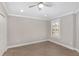 Bright bedroom with luxury vinyl plank flooring, neutral walls and a large shuttered window at 17760 Se 91St Gaylark Ave, The Villages, FL 32162