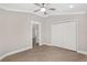 Bright bedroom with luxury vinyl plank flooring, neutral walls and a double door closet at 17760 Se 91St Gaylark Ave, The Villages, FL 32162