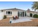 Back of home showing patio, sliding glass doors, and neutral exterior at 17760 Se 91St Gaylark Ave, The Villages, FL 32162