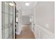 Bright foyer with light wood floors, white trim, and decorative glass front door at 17760 Se 91St Gaylark Ave, The Villages, FL 32162