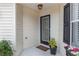 A welcoming front entry with a black door, flower boxes, and well-kept landscaping at 17760 Se 91St Gaylark Ave, The Villages, FL 32162