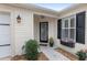 Inviting front entrance featuring a decorative door, black shutters, and flower accents at 17760 Se 91St Gaylark Ave, The Villages, FL 32162