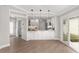 Modern kitchen with breakfast bar, pendant lighting, and white cabinetry at 17760 Se 91St Gaylark Ave, The Villages, FL 32162