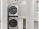 A modern stacked washer and dryer in a dedicated laundry area at 17760 Se 91St Gaylark Ave, The Villages, FL 32162