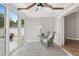 Cozy sunroom with wicker furniture, tiled floors, and sliding glass doors leading to a patio at 17760 Se 91St Gaylark Ave, The Villages, FL 32162