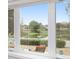 Picturesque window view of backyard pond and well maintained lawn at 17760 Se 91St Gaylark Ave, The Villages, FL 32162