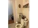 Bathroom with toilet, storage, and decorative accents at 185 Jacaranda Dr, Leesburg, FL 34748