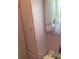 Pink bathroom with linen closet and window at 185 Jacaranda Dr, Leesburg, FL 34748