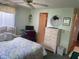 Bedroom with double bed, dresser, and access to bathroom at 185 Jacaranda Dr, Leesburg, FL 34748