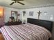 Main bedroom with a king-size bed and a large mirror at 185 Jacaranda Dr, Leesburg, FL 34748