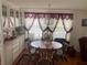 Charming dining area with wood table, chandelier, and built-in hutch at 185 Jacaranda Dr, Leesburg, FL 34748