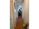 Bright hallway with wood-look flooring, leading to living area at 185 Jacaranda Dr, Leesburg, FL 34748