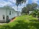 Side view of a white single wide mobile home at 185 Jacaranda Dr, Leesburg, FL 34748