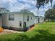 Side view of a white single wide mobile home at 185 Jacaranda Dr, Leesburg, FL 34748